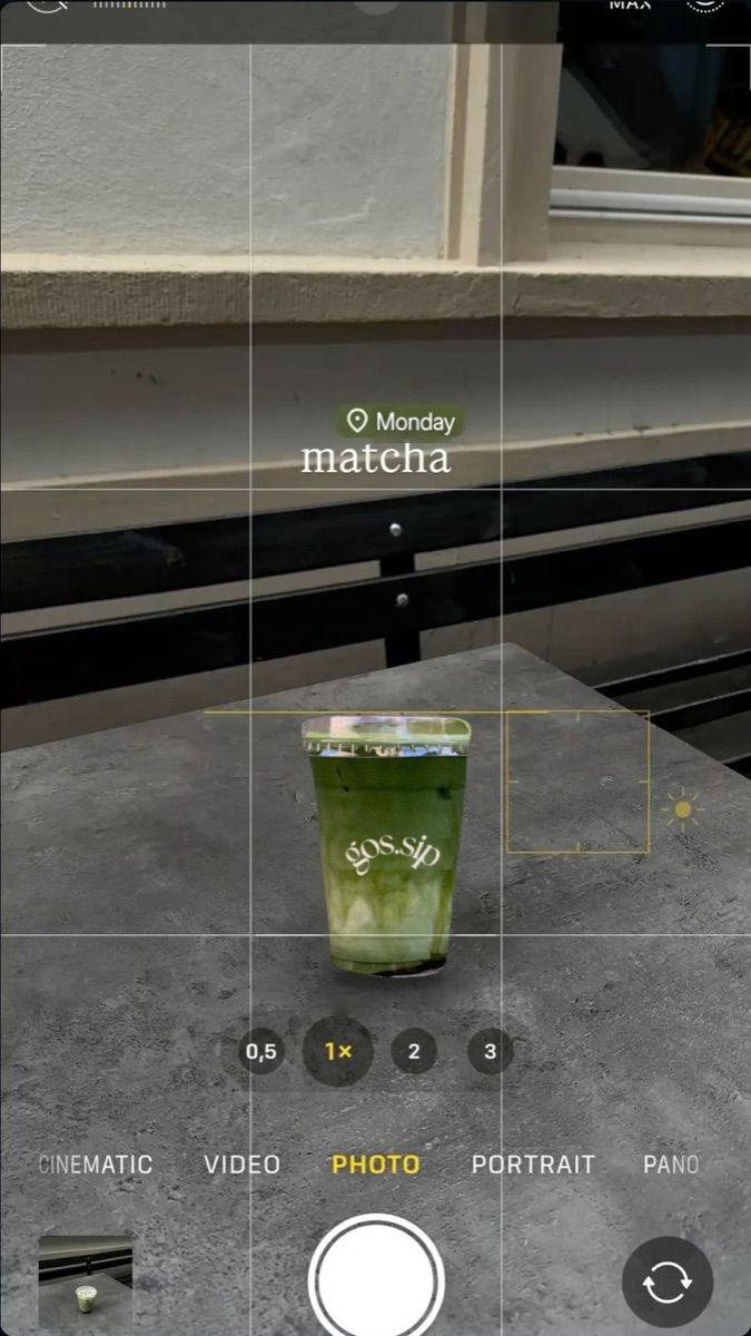 A gos.sip iced matcha latte on a sunny windowsill